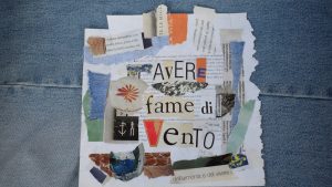 A collage with text "avere fame di vento" on denim.